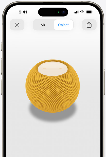 HomePod jaune en réalité augmentée sur l’écran d’un iPhone.