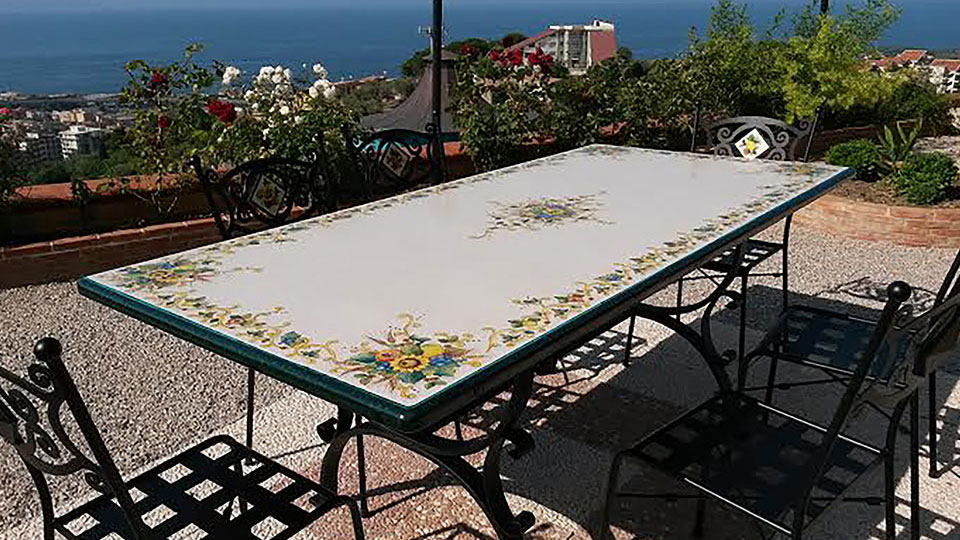 lava stone table with chairs overlooking the sea