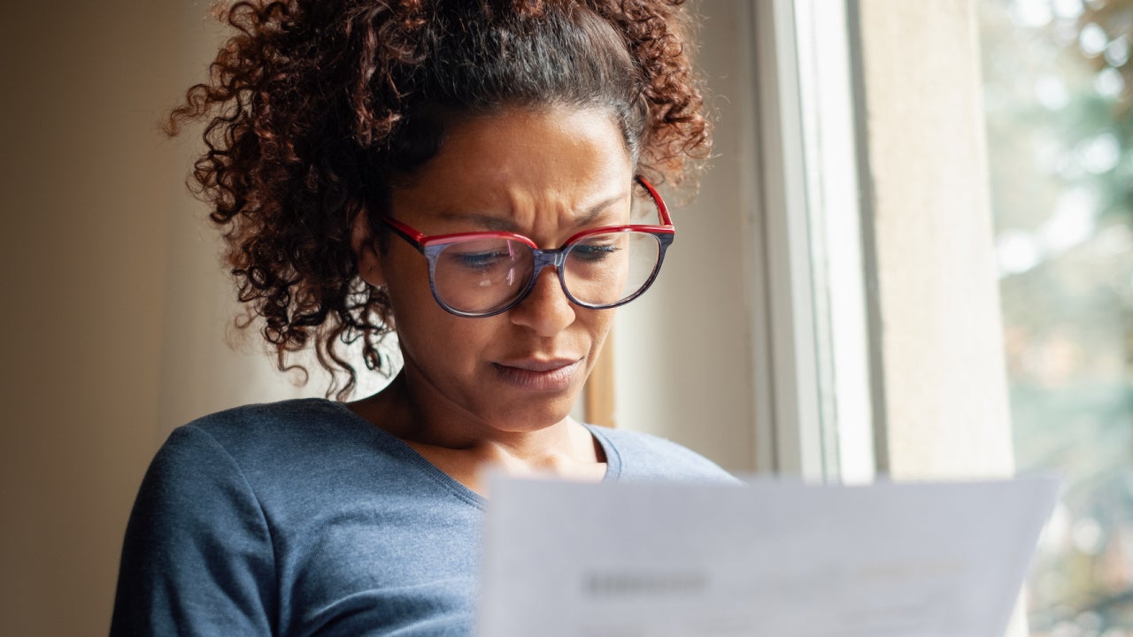 Concerned black woman looking at her finances