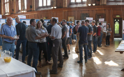 A group of people standing around a table.