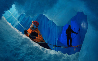 A woman and a man in an ice cave