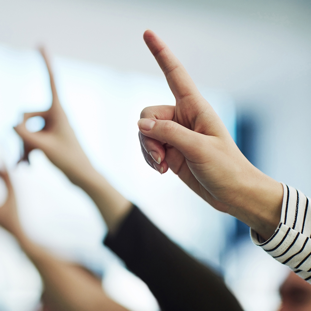 Photo of raised hands.