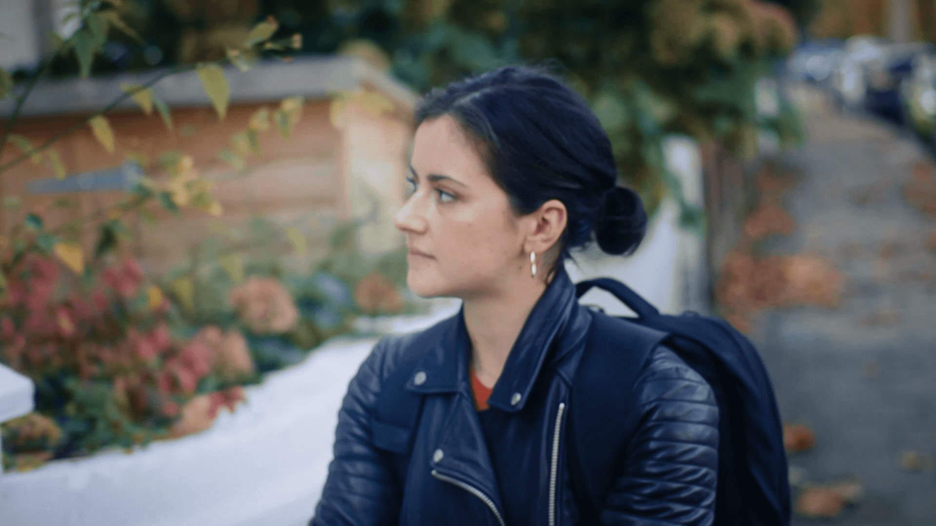 Side profile of a young woman walking down the street