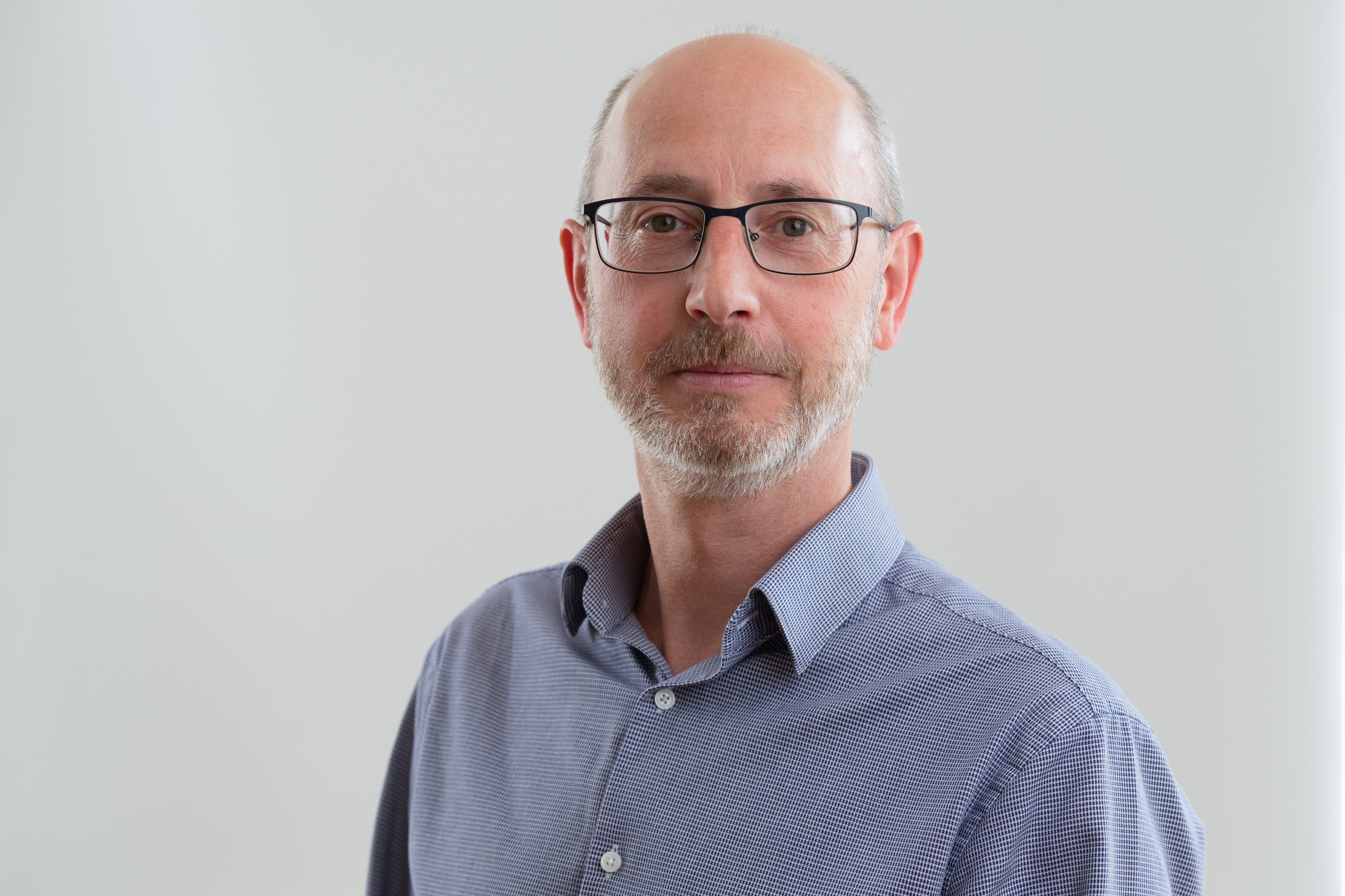 Man in a blue shirt with glasses 