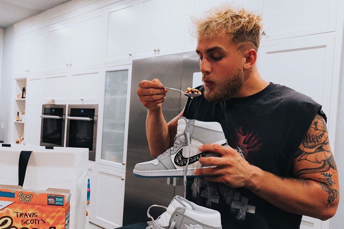 Tattooed person eats cereal stylishly.