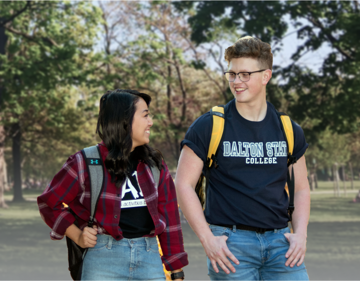 Male and female student with backpacks walking and smiling