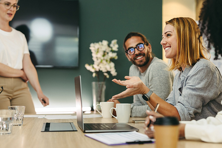 Four people around a table talking