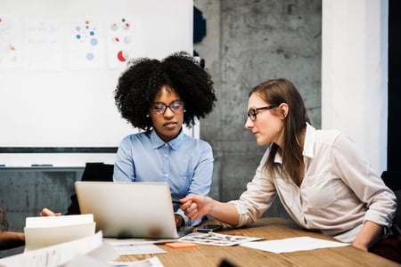 coworkers analyzing SaaS metrics