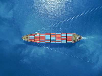 Aerial view of a ship carrying containers in the water