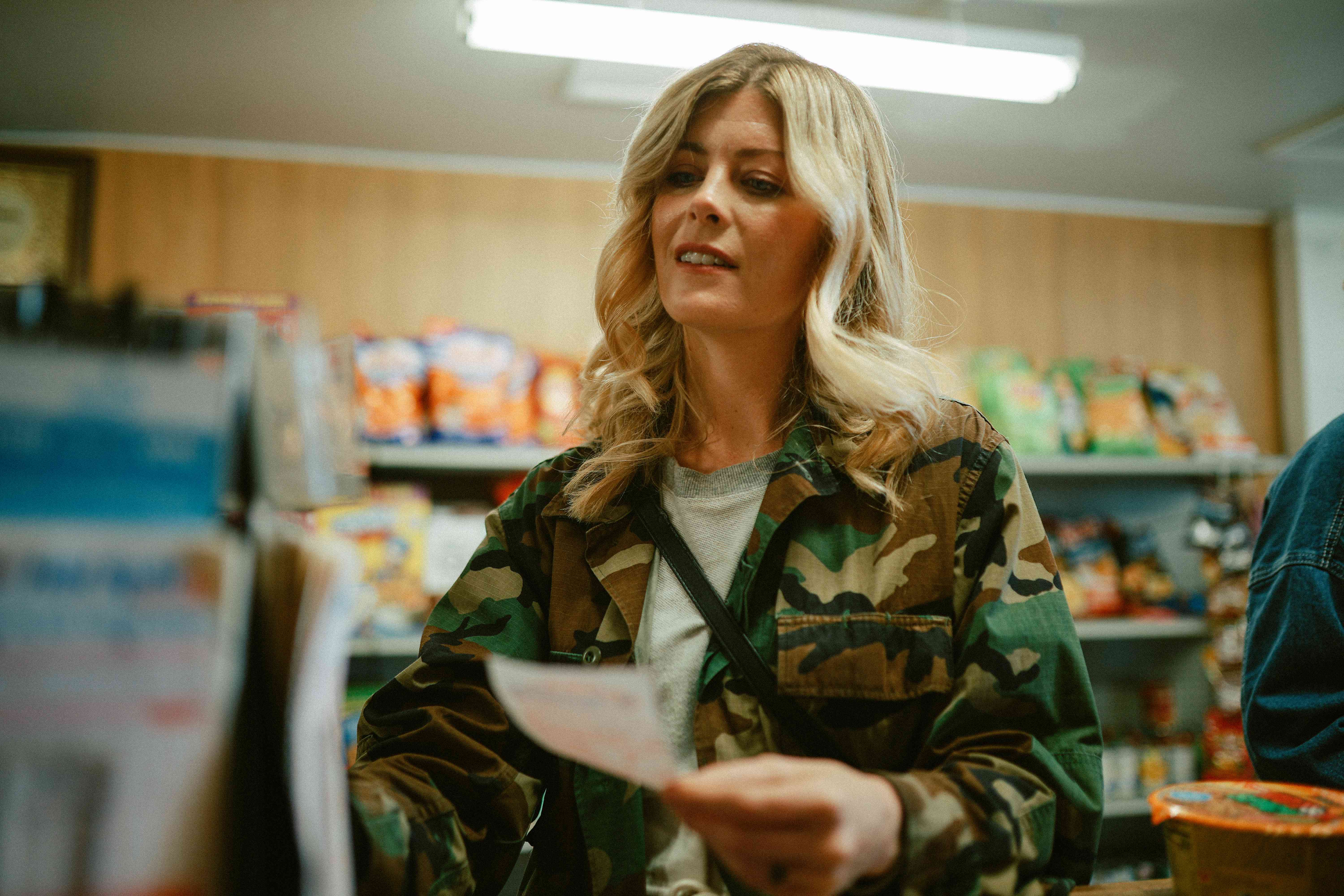 Woman buying a lottery ticket at a convenience store