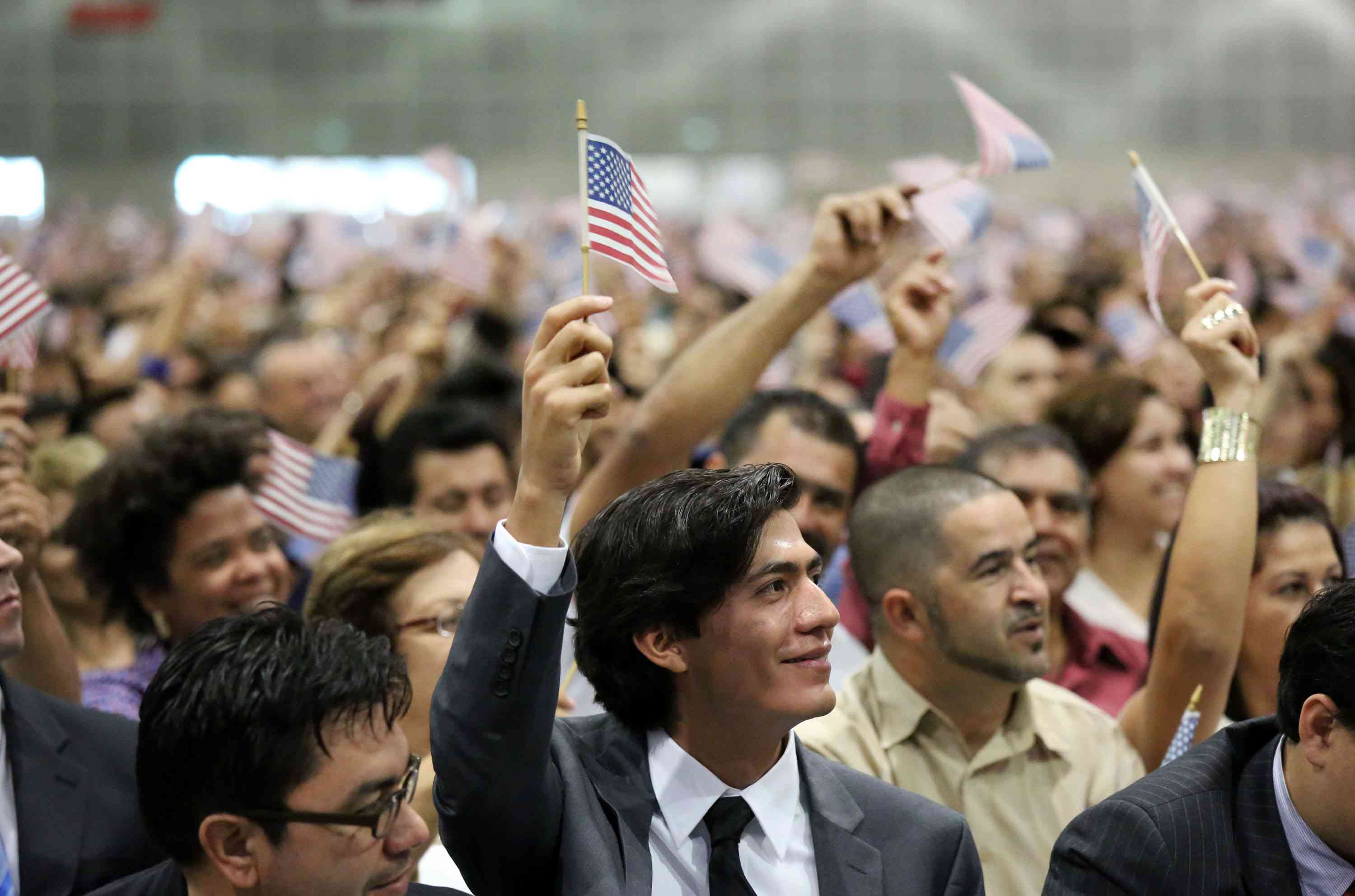 Immigrants being sworn in as U.S. citizens represent the process of acculturation.