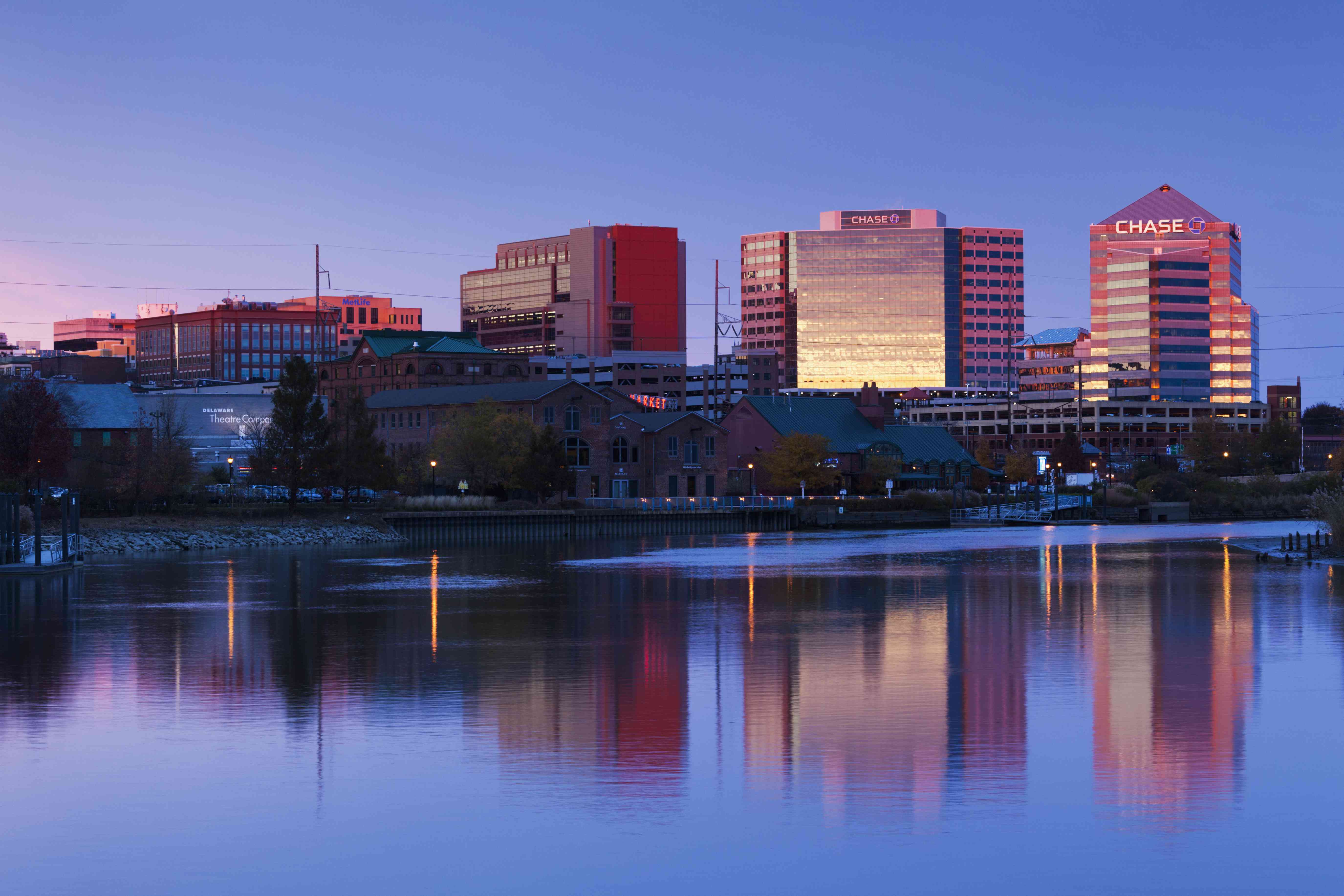 The downtown skyline of corporate tax haven, Wilmington, Delaware, reflects into the Christina River at dusk.