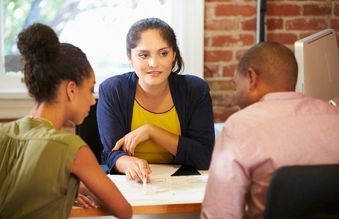 Tax preparer talks to two clients