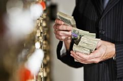 Man With Cash by Safety Deposit Boxes