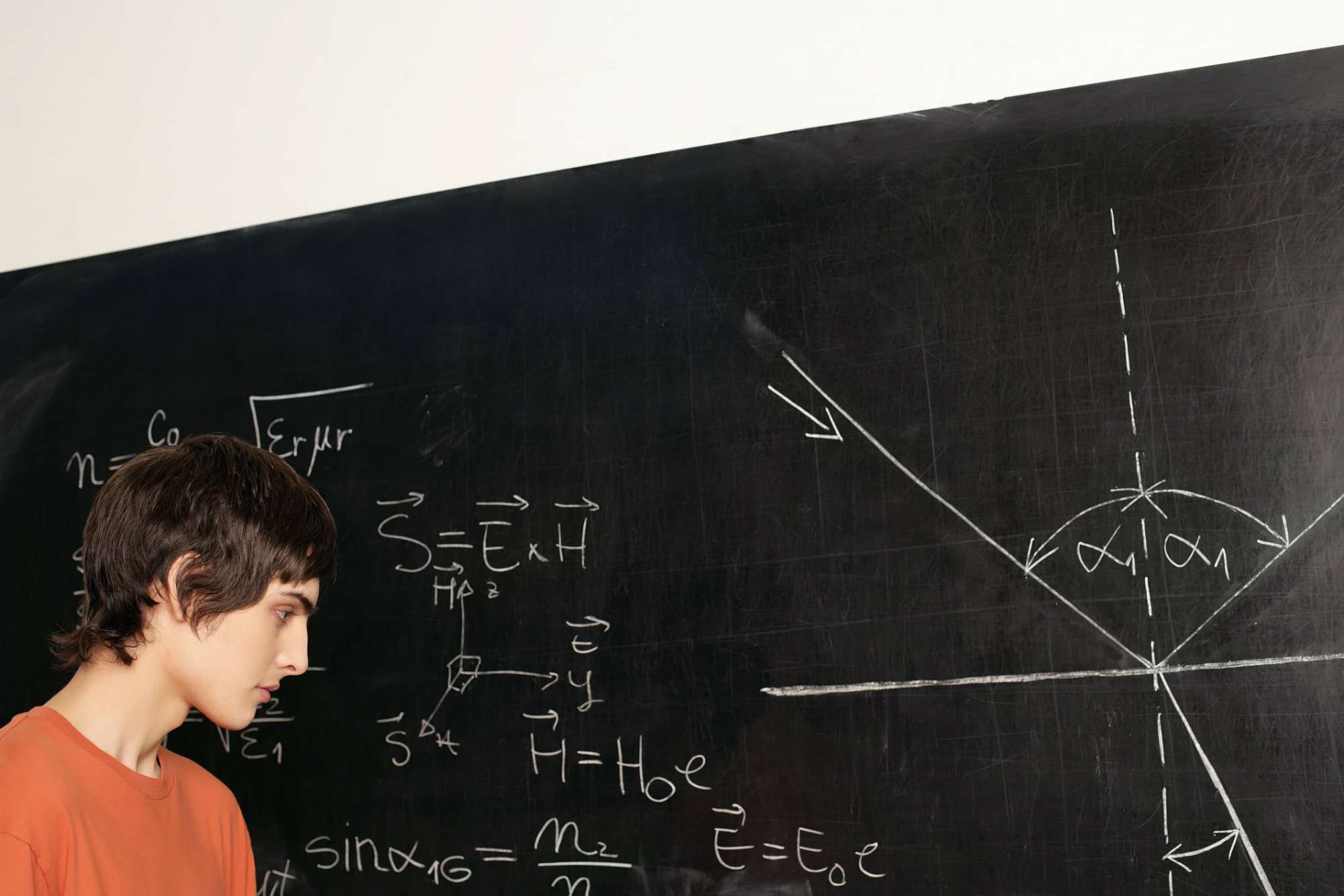 Student looking at equation on blackboard