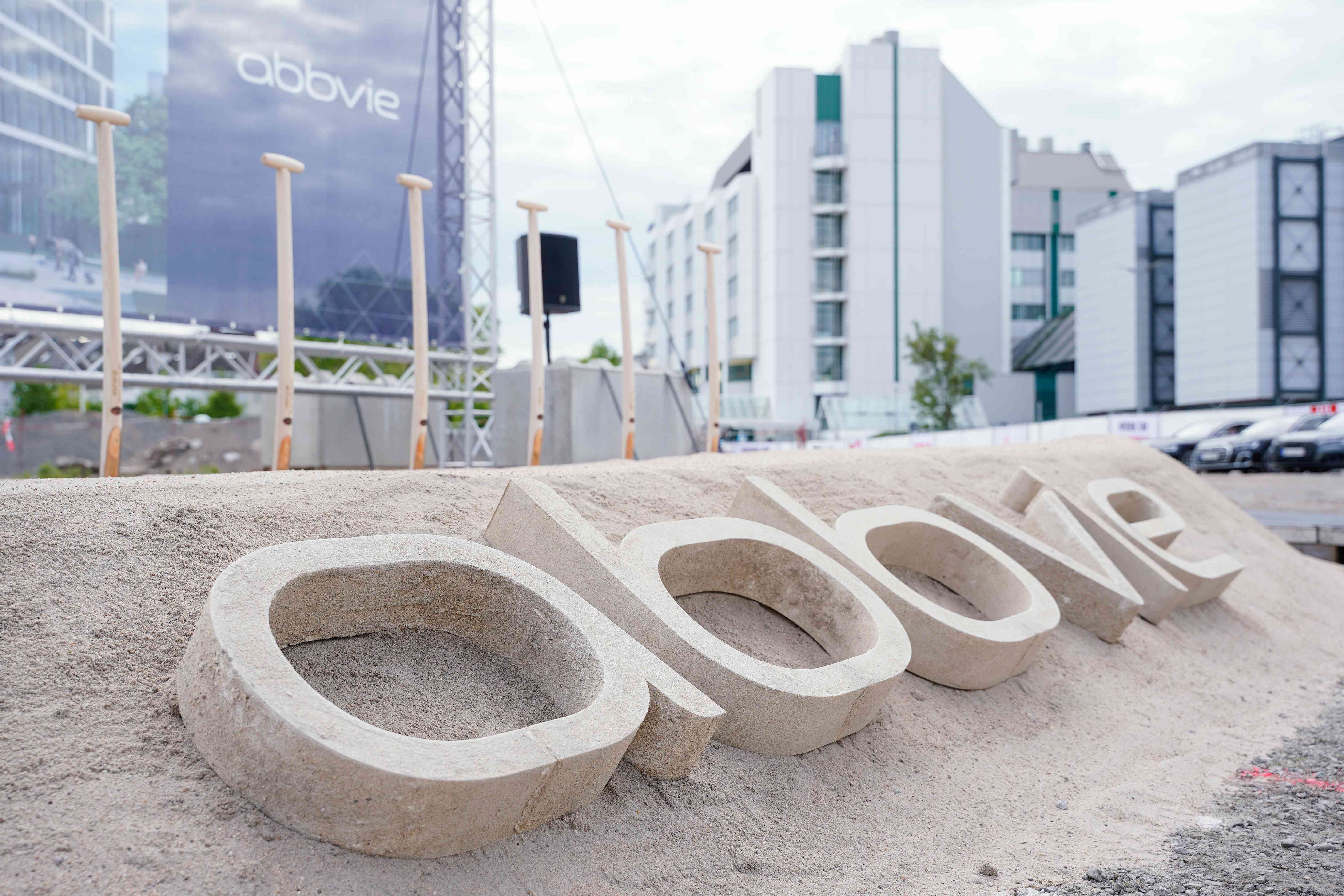 A company logo is displayed on a sand hill on the premises of the pharmaceutical company AbbVie at the official ground-breaking ceremony for the construction of a new research and development building in Germany