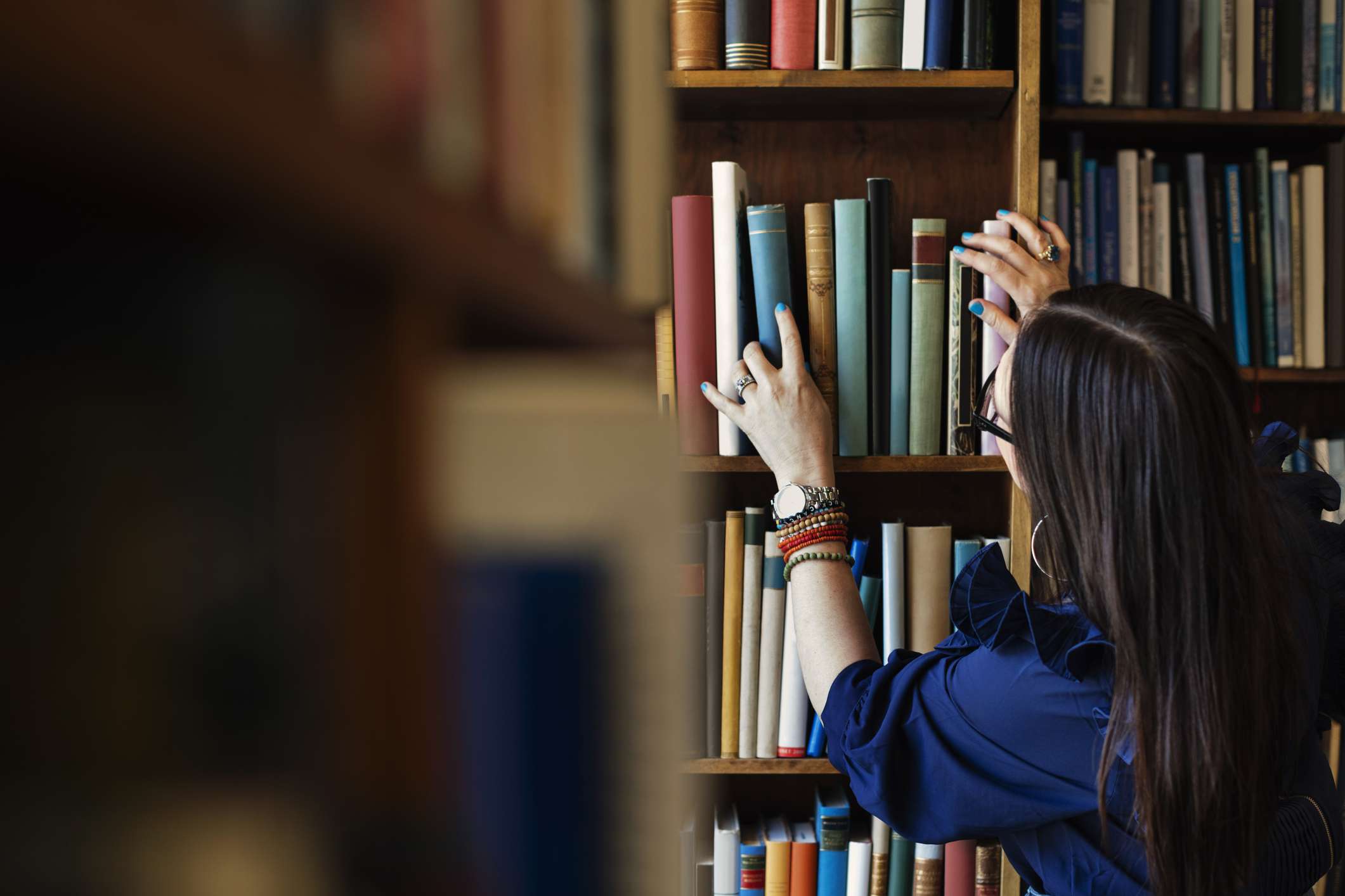 Woman at Library Shelves