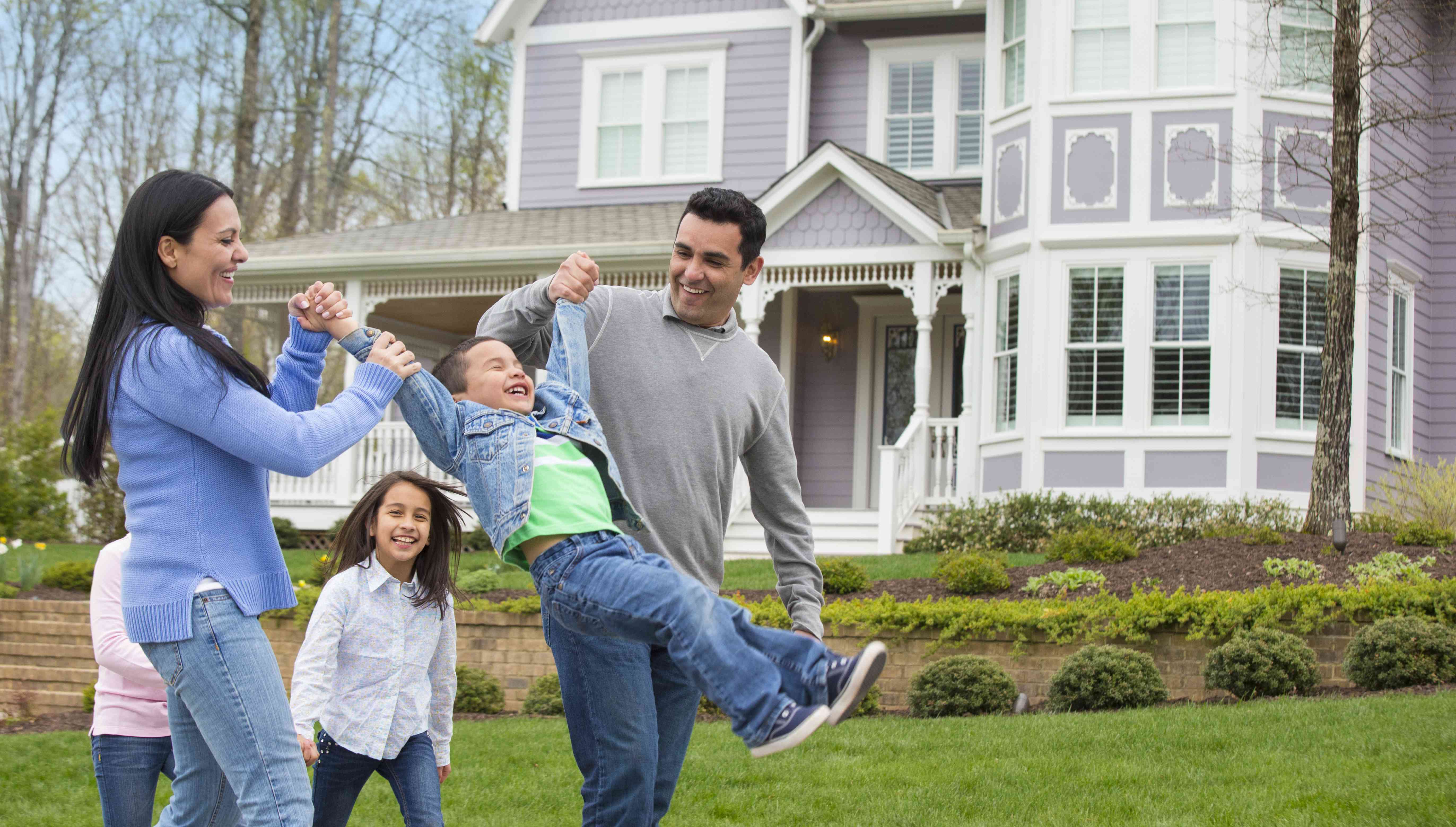 Hispanic family playing in front yard