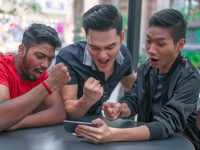 Group of friends playing mobile games on smartphone