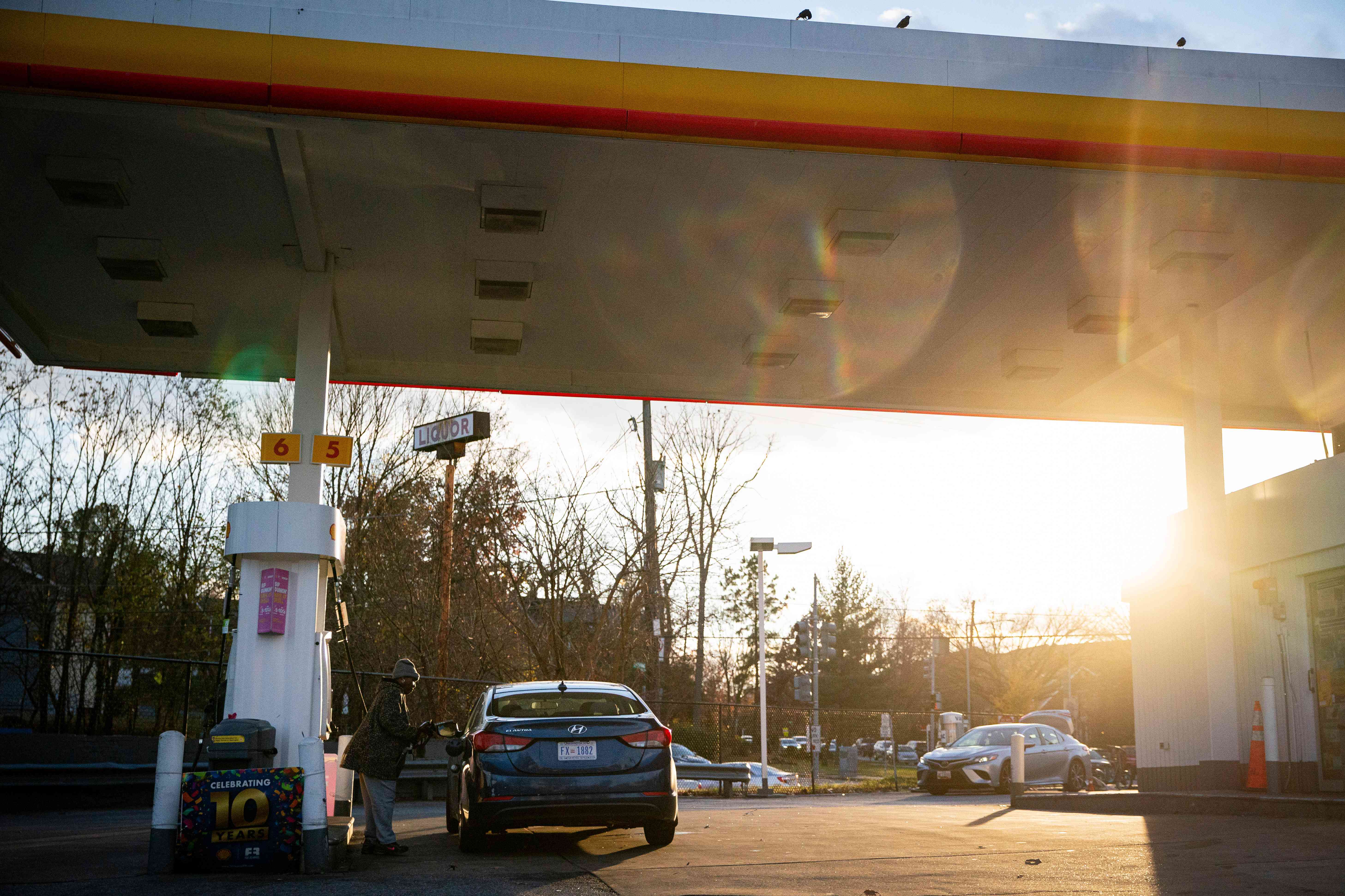 A driver pumps gas at a Shell gas station in Washington, DC, US, on Tuesday, Nov. 28, 203. Gasoline prices have fallen for 60 consecutive days, the longest streak of declines in more than a year, letting American drivers pass on savings at the pump to consumer retailers during the US economy's all-important holiday season.