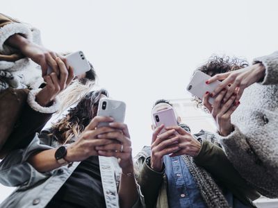 Group of friends in the street with smartphones