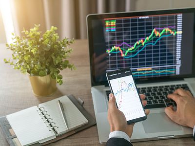 Investor Analyzing Stock Market Investments With Financial Dashboard, Business Intelligence (BI), and Key Performance Indicators (KPI) on Smartphone and Computer Screens