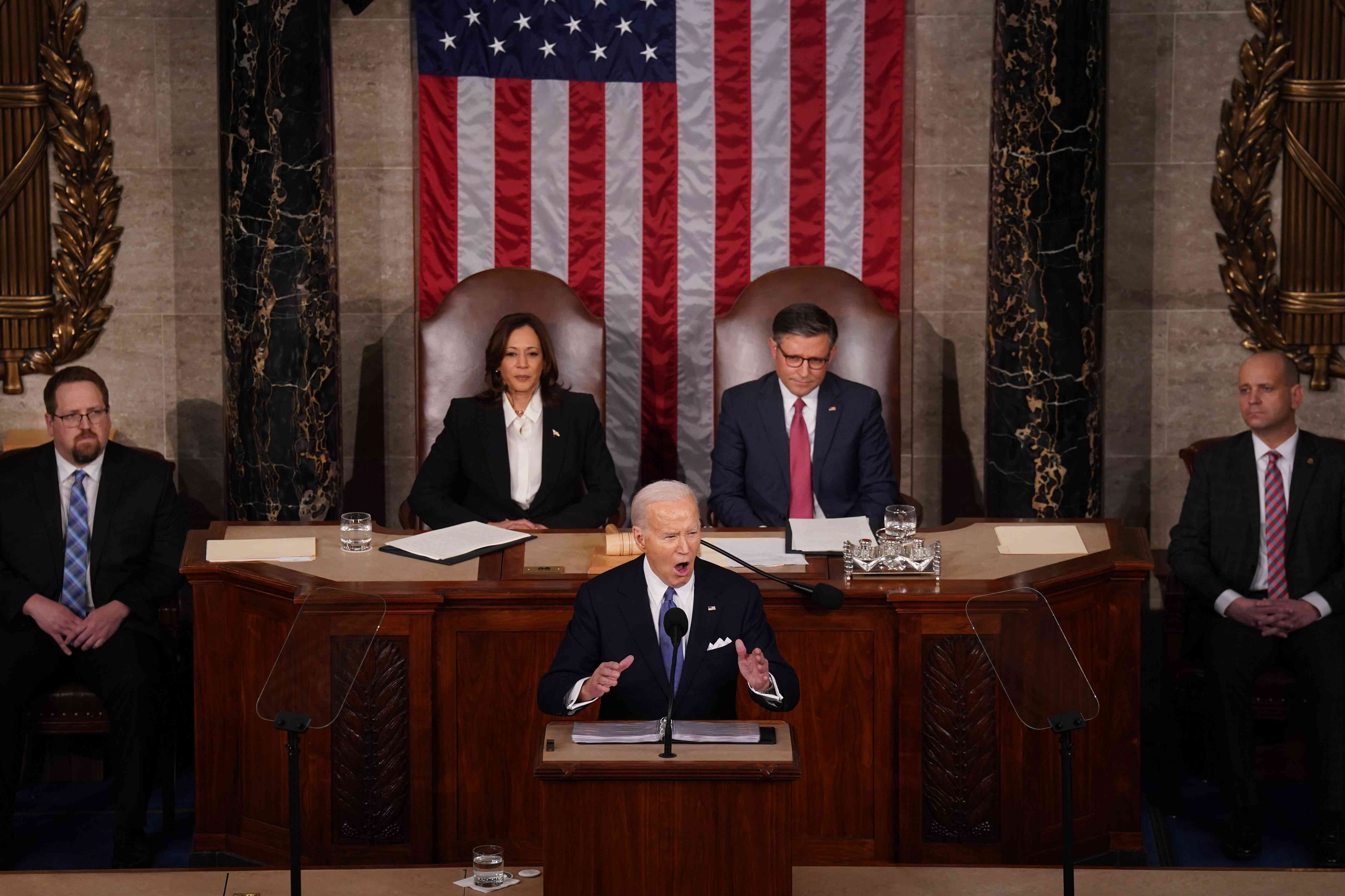 US President Joe Biden, center, speaks during a State of the Union address at the US Capitol in Washington, DC, US, on Thursday, March 7, 2024. 