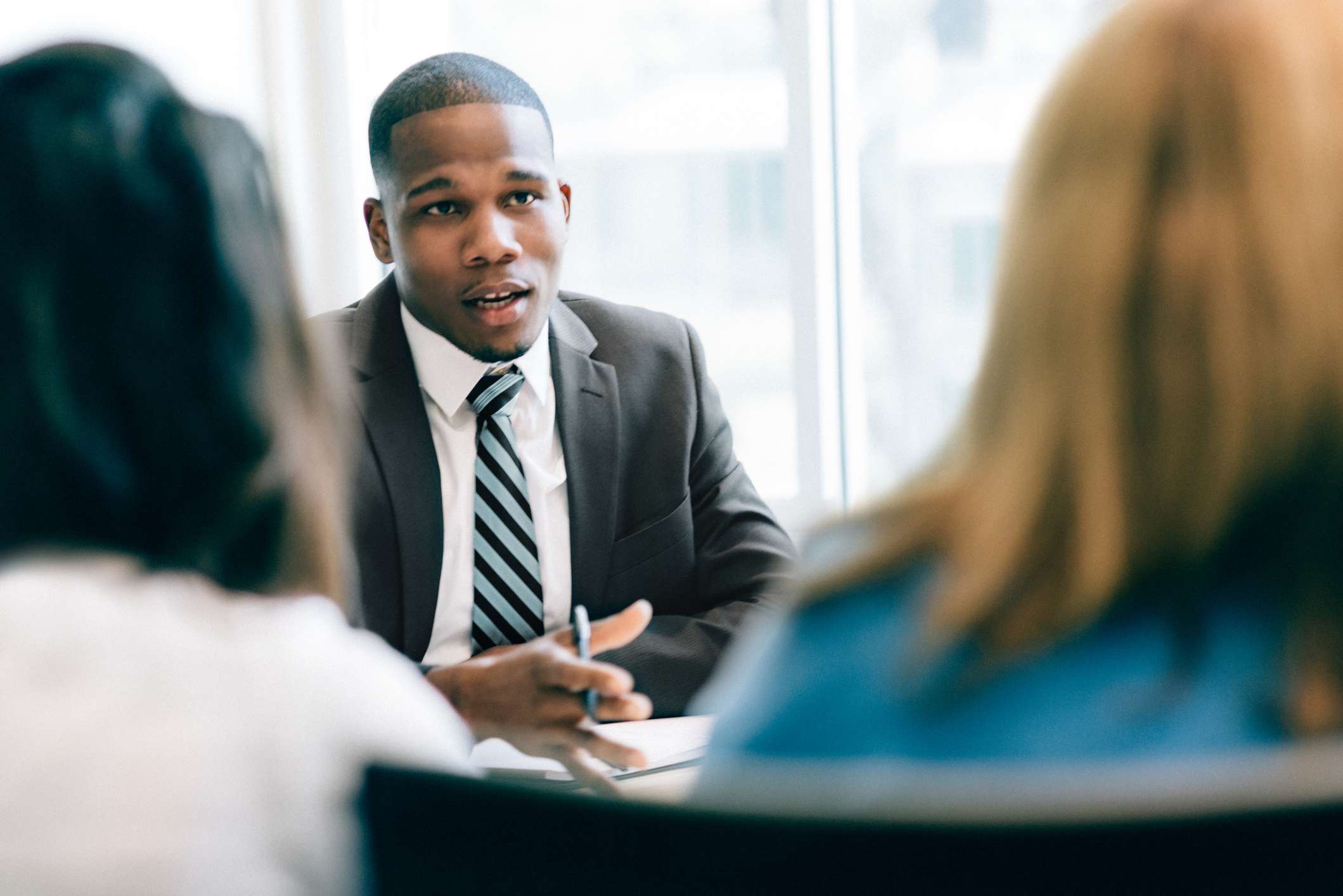 Two women meet with a financial specialist 