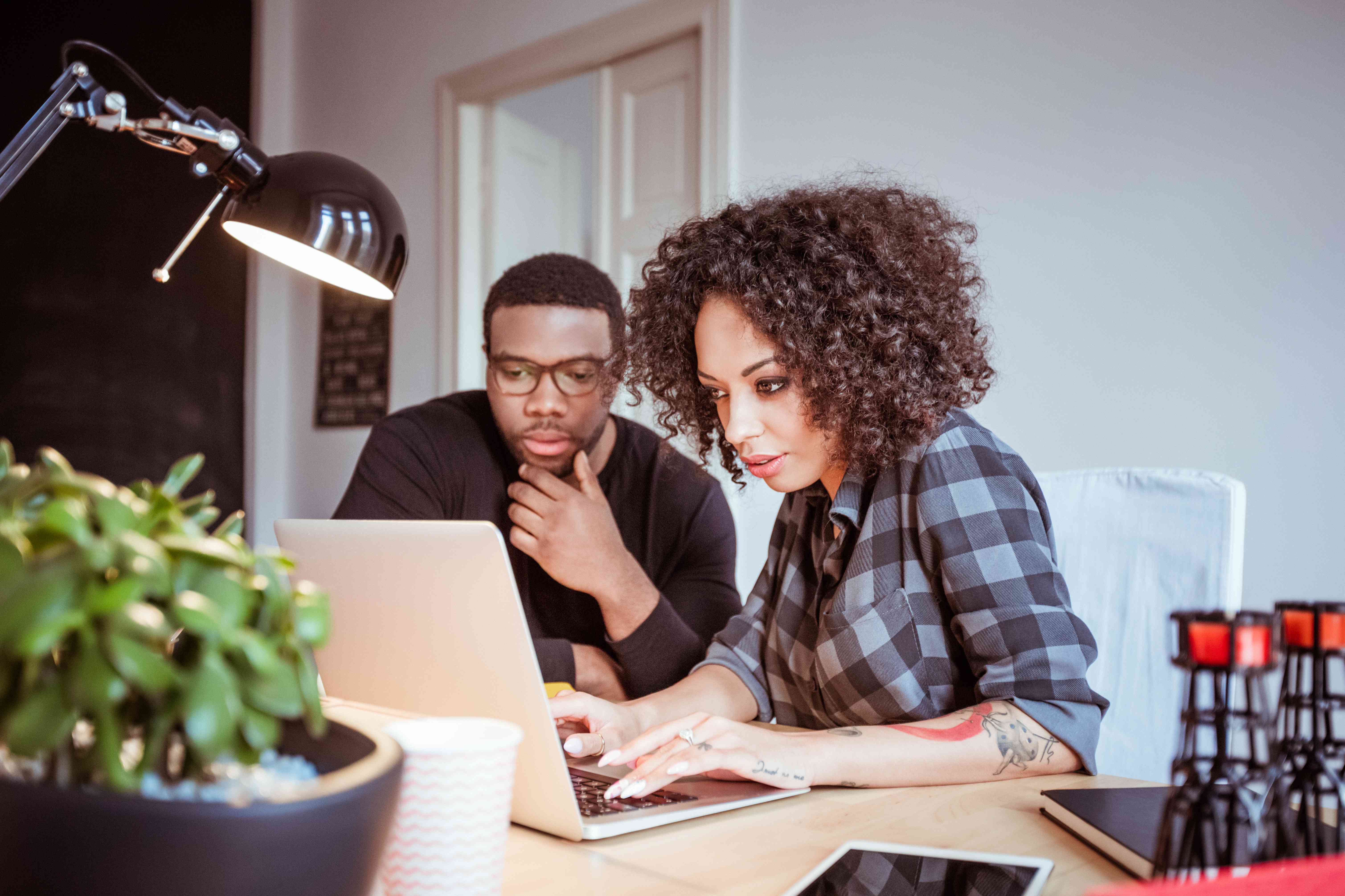 Young Black couple looking at laptop together