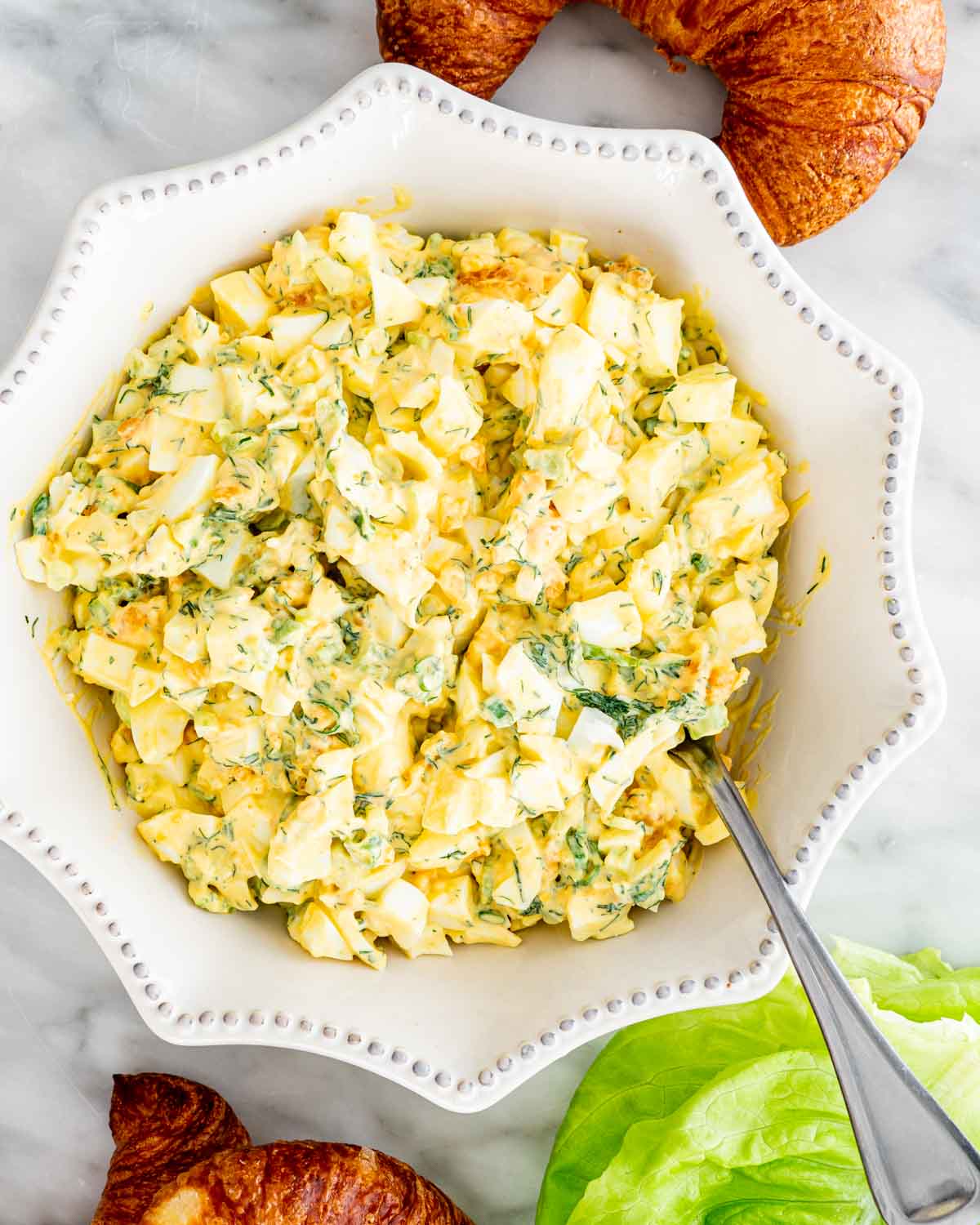 overhead shot of egg salad in a white bowl