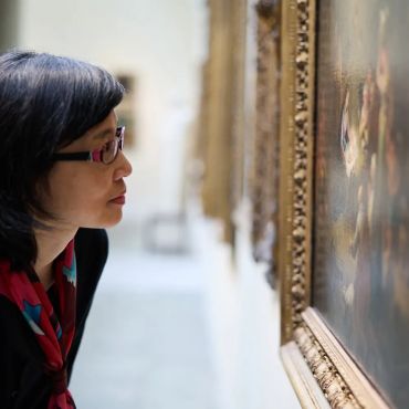 Woman gazes at a painting at the Christ Church Picture Gallery