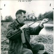 An angler fishing on an Oxfordshire riverbank, 1965