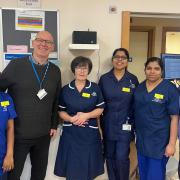 John Couppletich presents Jayne Brown, Rowan Ambulatory Unit manager, and staff at the unit, with a Wi-Fi radio