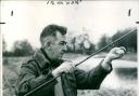 An angler fishing on an Oxfordshire riverbank, 1965