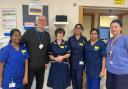 John Couppletich presents Jayne Brown, Rowan Ambulatory Unit manager, and staff at the unit, with a Wi-Fi radio