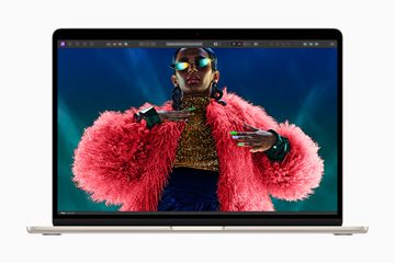 M3 MacBook Air with a Black woman in an amazing pink fluffy jacket on the screen.