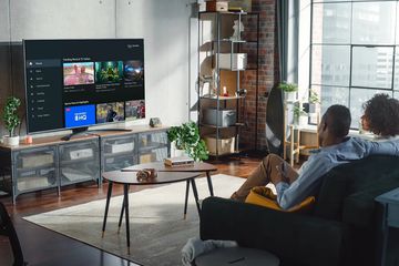 A couple using Amazon's Fire TV Channels app on their television. 