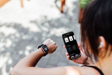 A runner selecting Apple Watch faces using an Apple Watch and iPhone