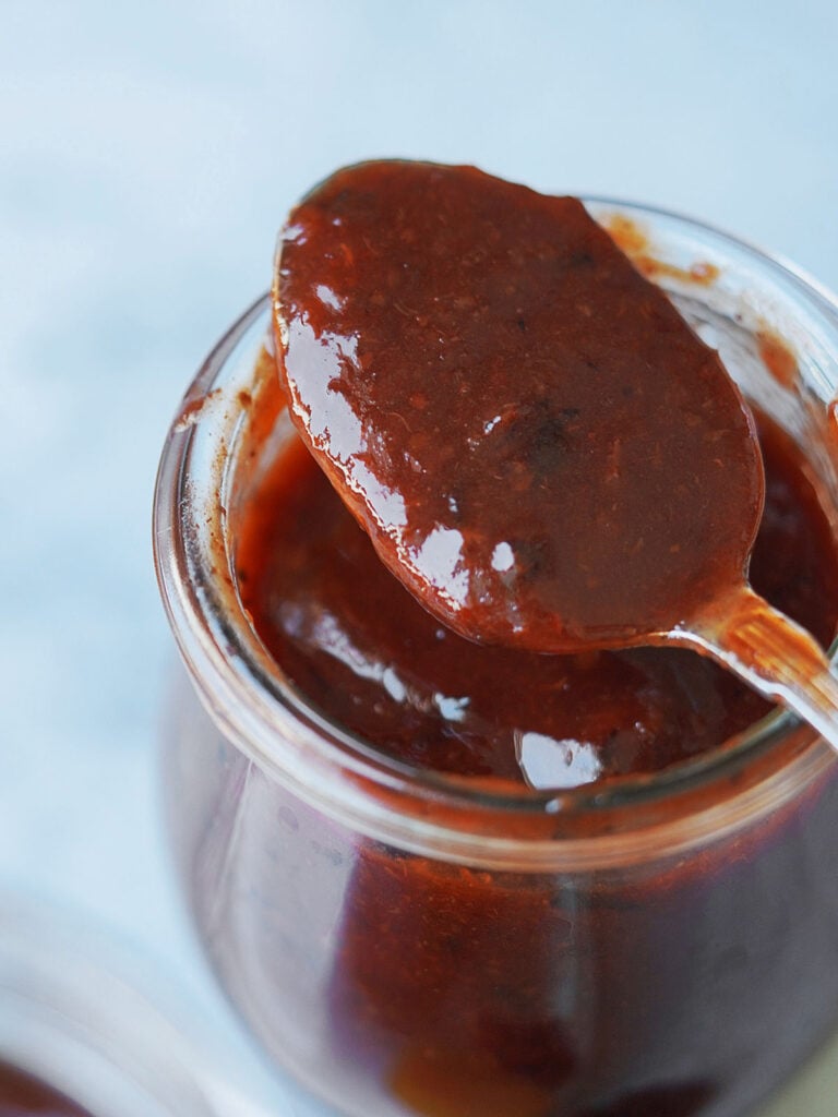 Close up photo of Homemade chamoy on a spoon.