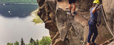 Woman rock climbing and rappelling