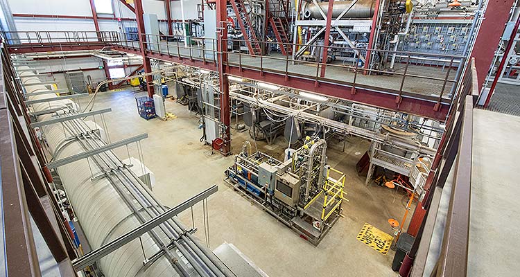 Photo of a large, industrial space with two floors of testing equipment.