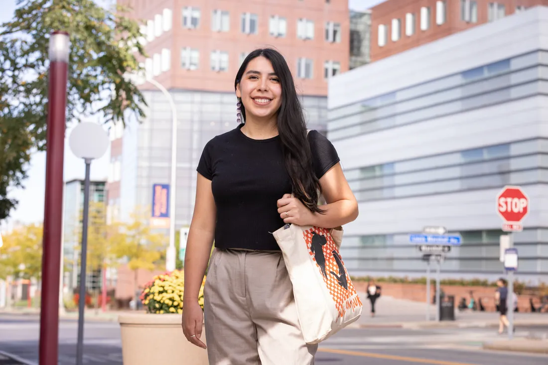 A person standing on a college campus.