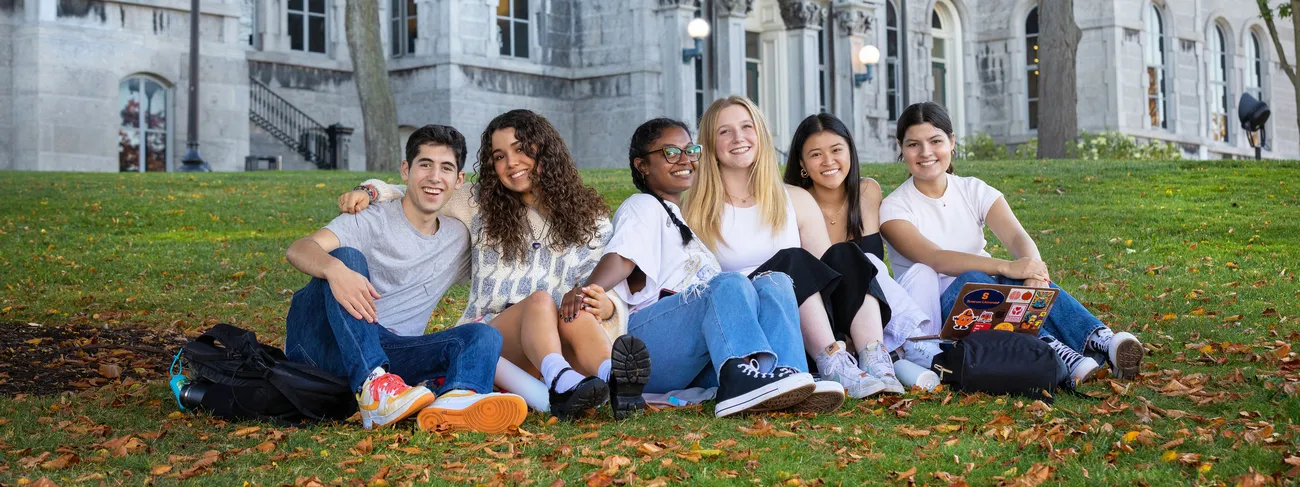 A group of people sitting outside a building.