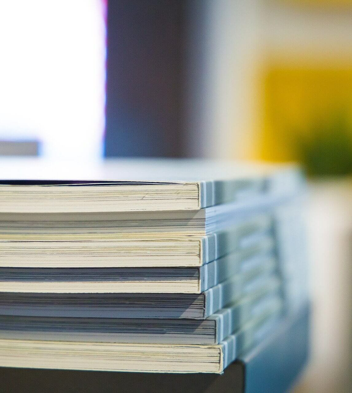 Close up of a pile of grey books.