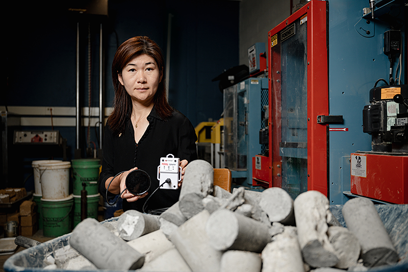 Purdue University professor Luna Lu holds the REBEL concrete strength sensing system