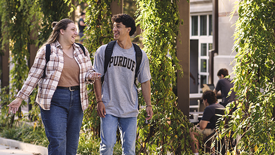 Two Purdue students walking outside of the Purdue Memorial Union.