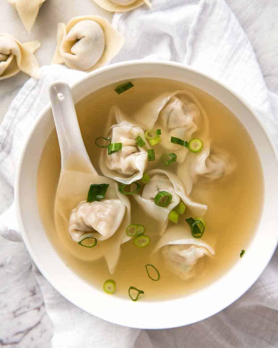 Wonton Soup in a white bowl, ready to be eaten