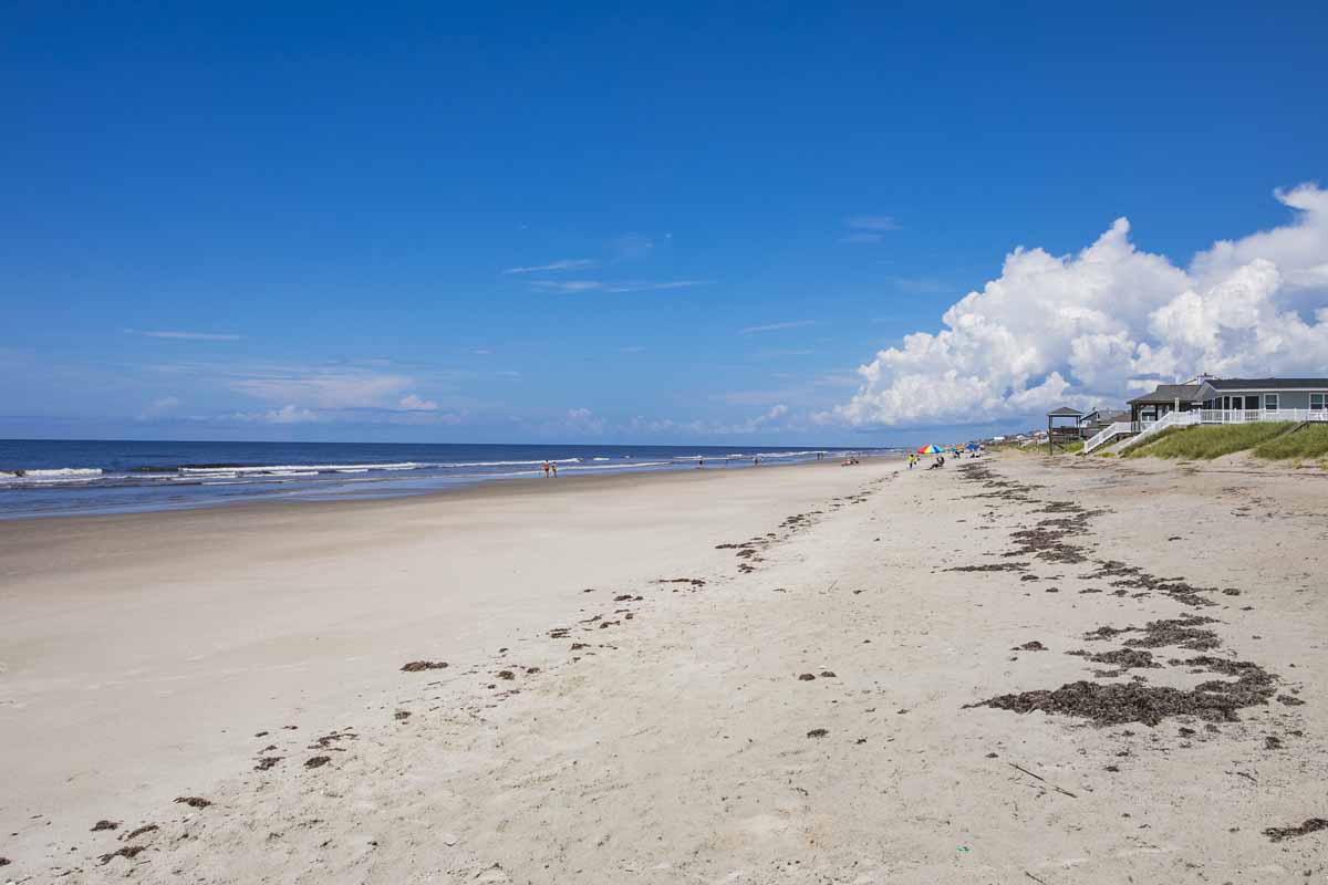 Sandy beach on a sunny day in Oak Island, NC