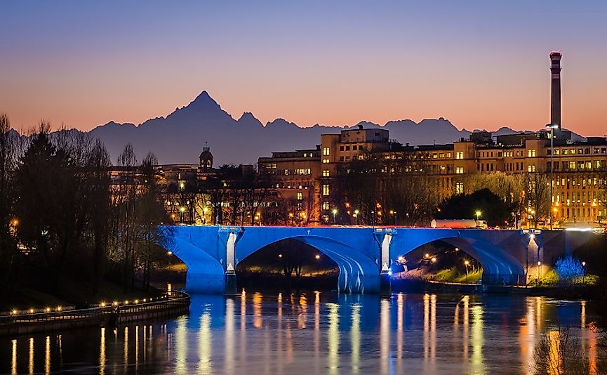 Turin along the banks of the Po River at sunset.