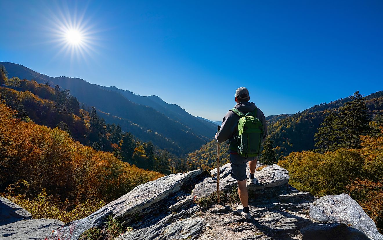 Hiker relaxing on a mountaintop, enjoying the autumn scenery in Smoky Mountains National Park near Gatlinburg, Tennessee.